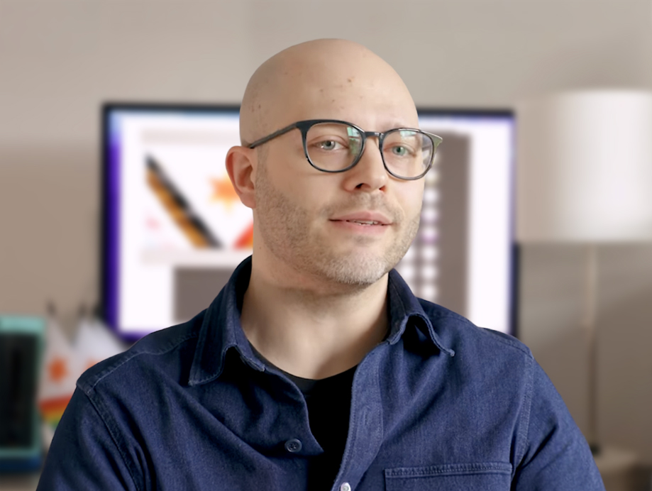 Eric Hart, owner of Hartbreakers Creative, working at his desk